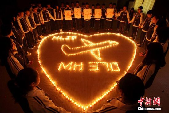 浙江諸暨海亮國際學校師生點燃蠟燭為馬航失聯飛機上的乘客祈福